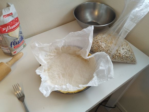 Lay down a crumpled sheet of parchment paper inside the pie crust.