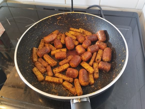 After a couple minutes, add the tofu and the spices. Cook until the tofu is firmer, somewhat crispy on the outside.